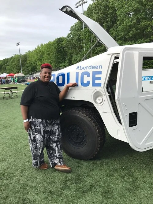 a person standing next to police truck