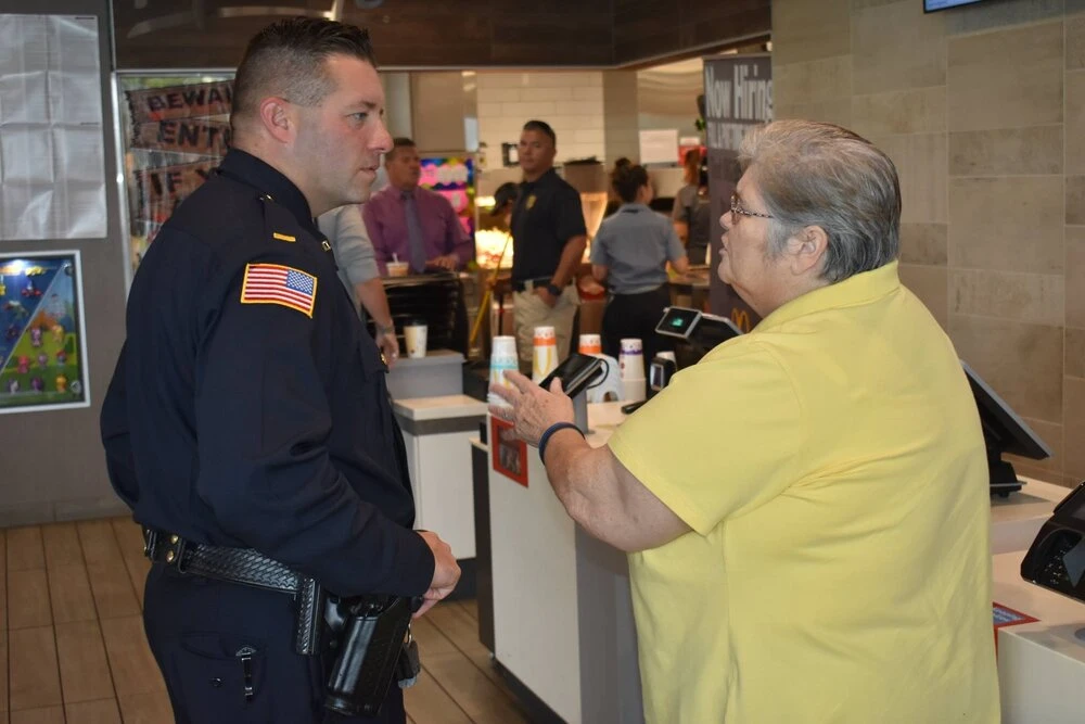 a man talking with a police officer