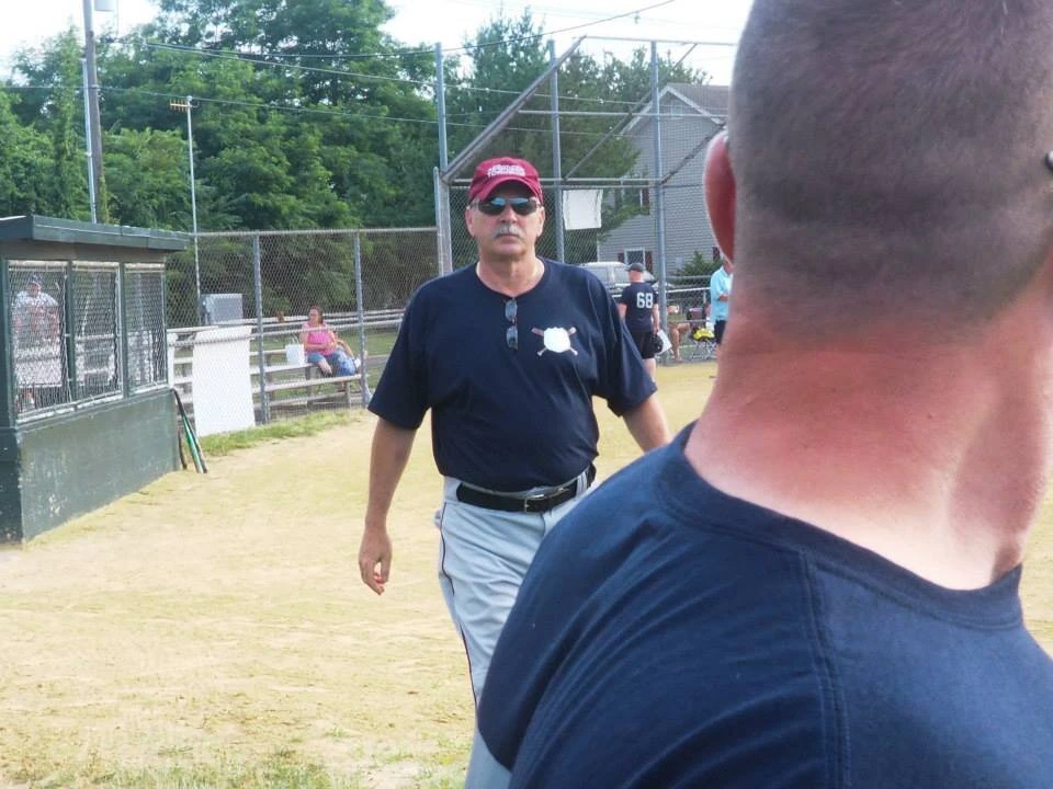 a person walks toward a baseball player