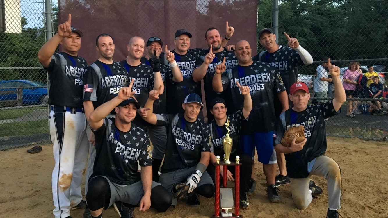 a group of people each with one hand raised in the air