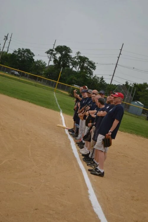 a baseball team lineup on the side of the field
