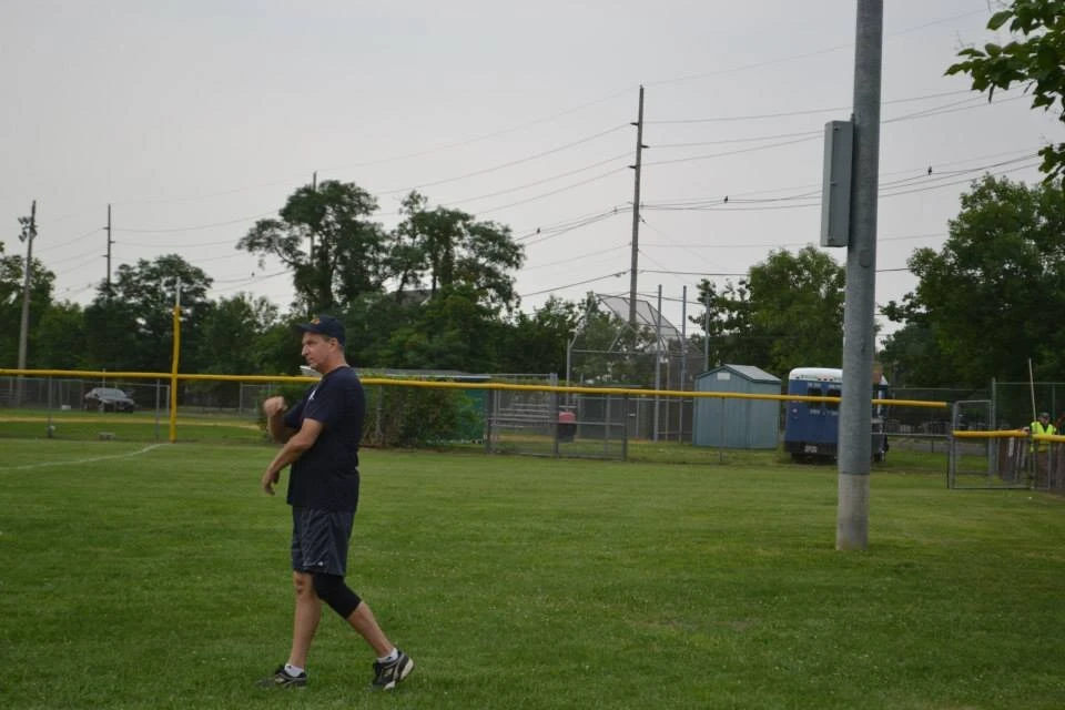 a person walks toward the end of a baseball field