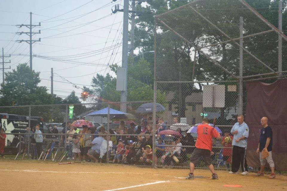 a crowd watches a baseball player at bat