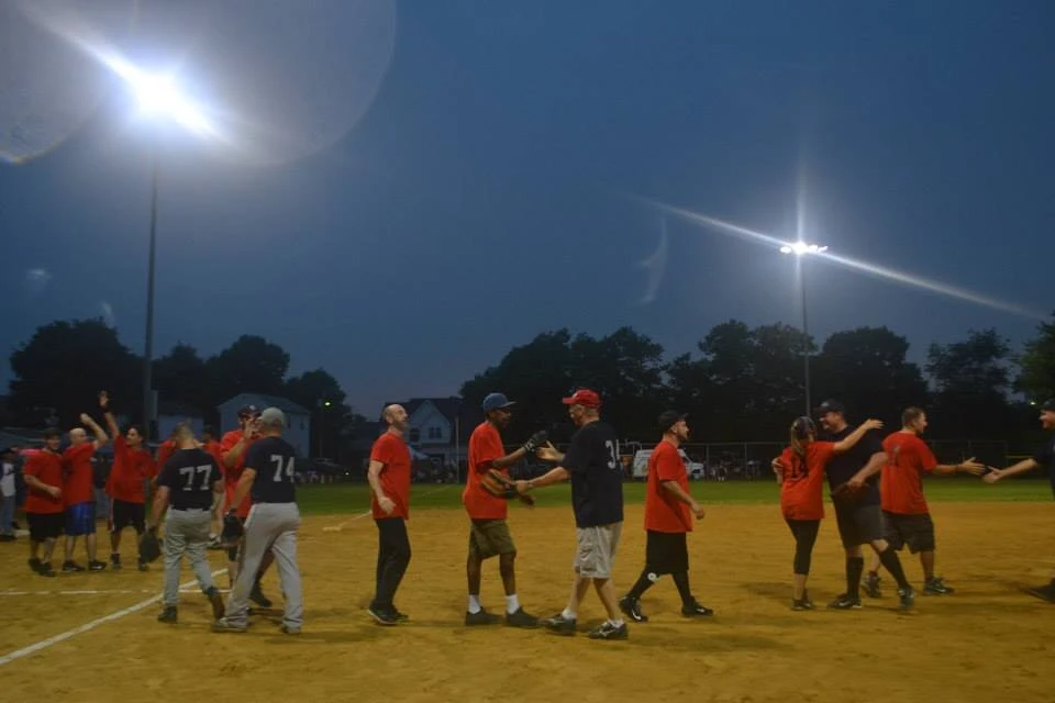 a baseball team walk across the field