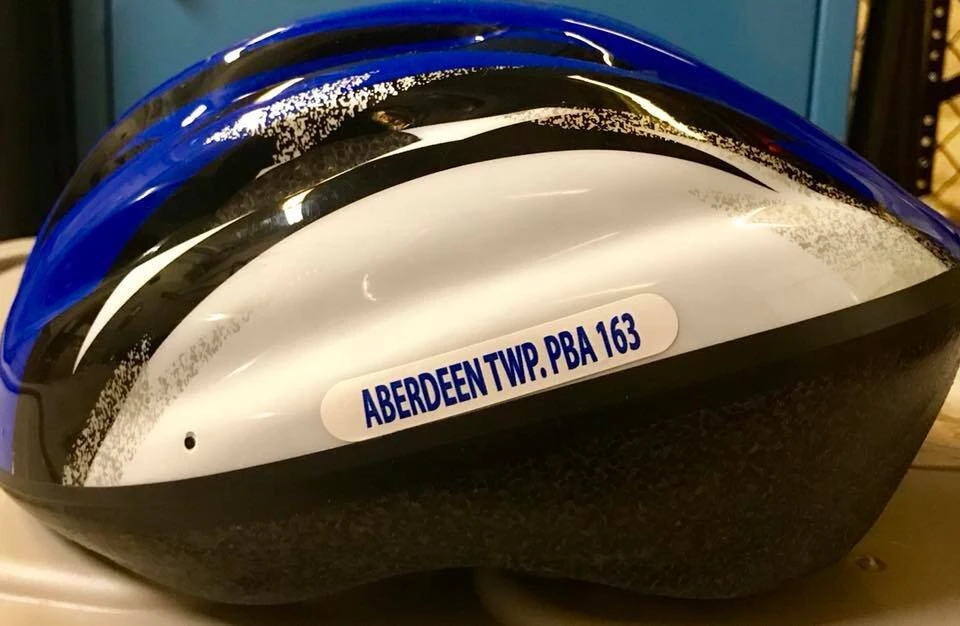 a bicycle helmet with Aberdeen PBA 163 nameplate on the side