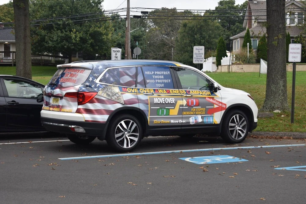a parked van with decal that says "Move over awareness campaign"