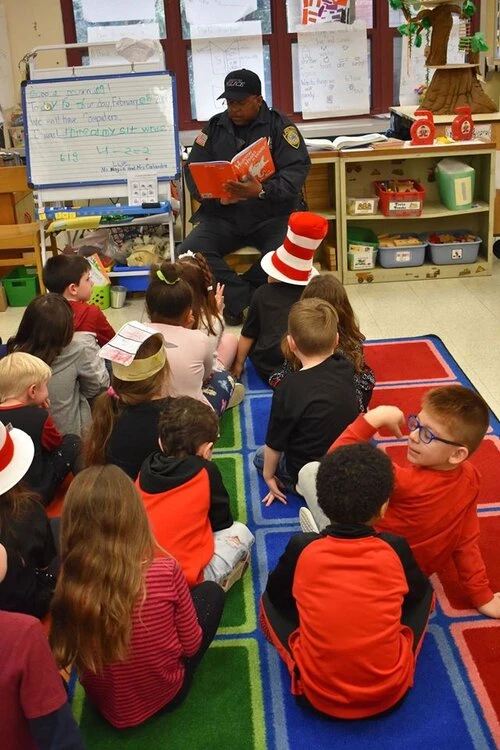 a police officer reads to children