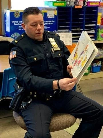 a police officer reading a book
