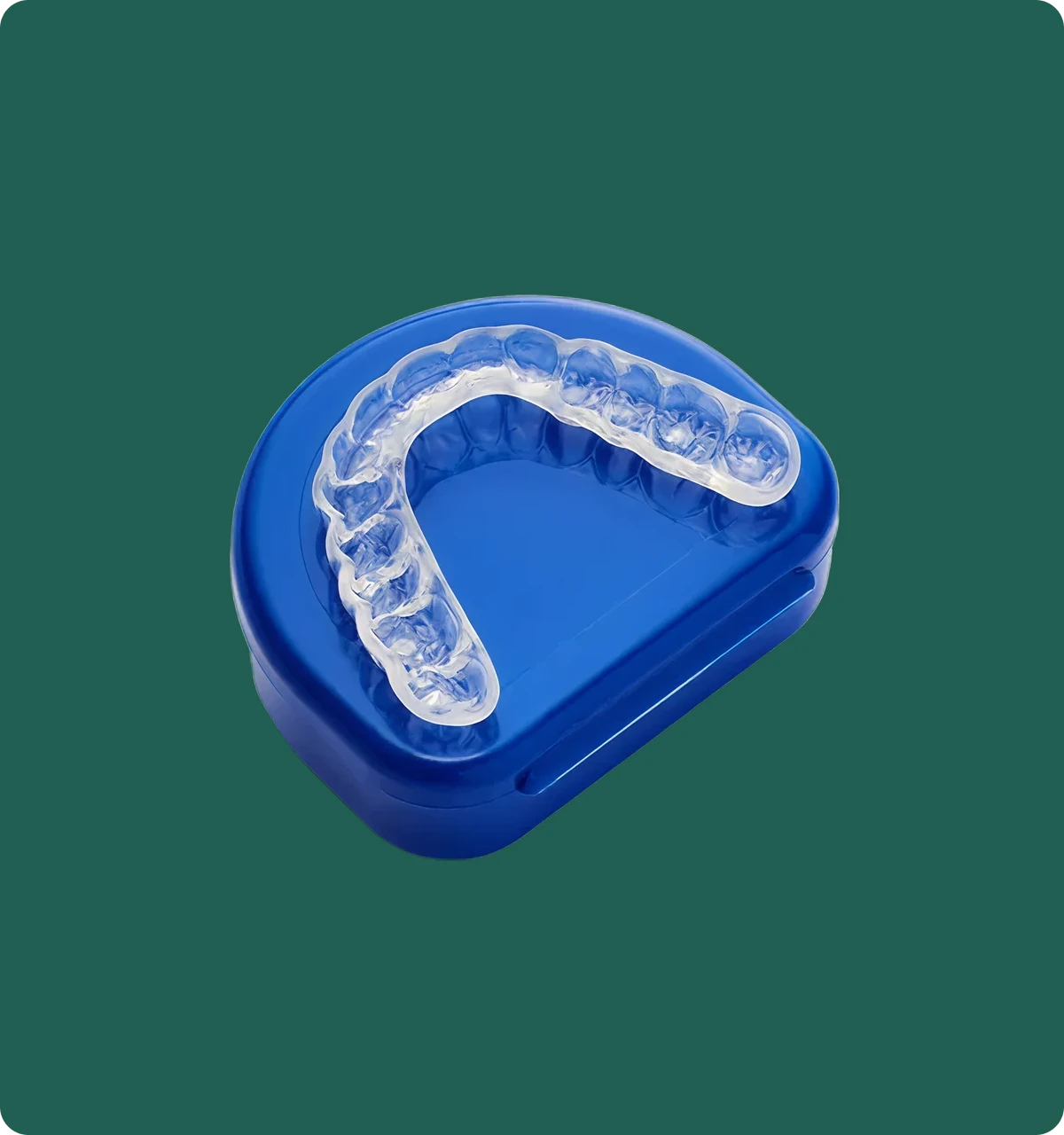 Close-up of a custom hard/soft night guard on a dental model, showing the dual-layer construction.