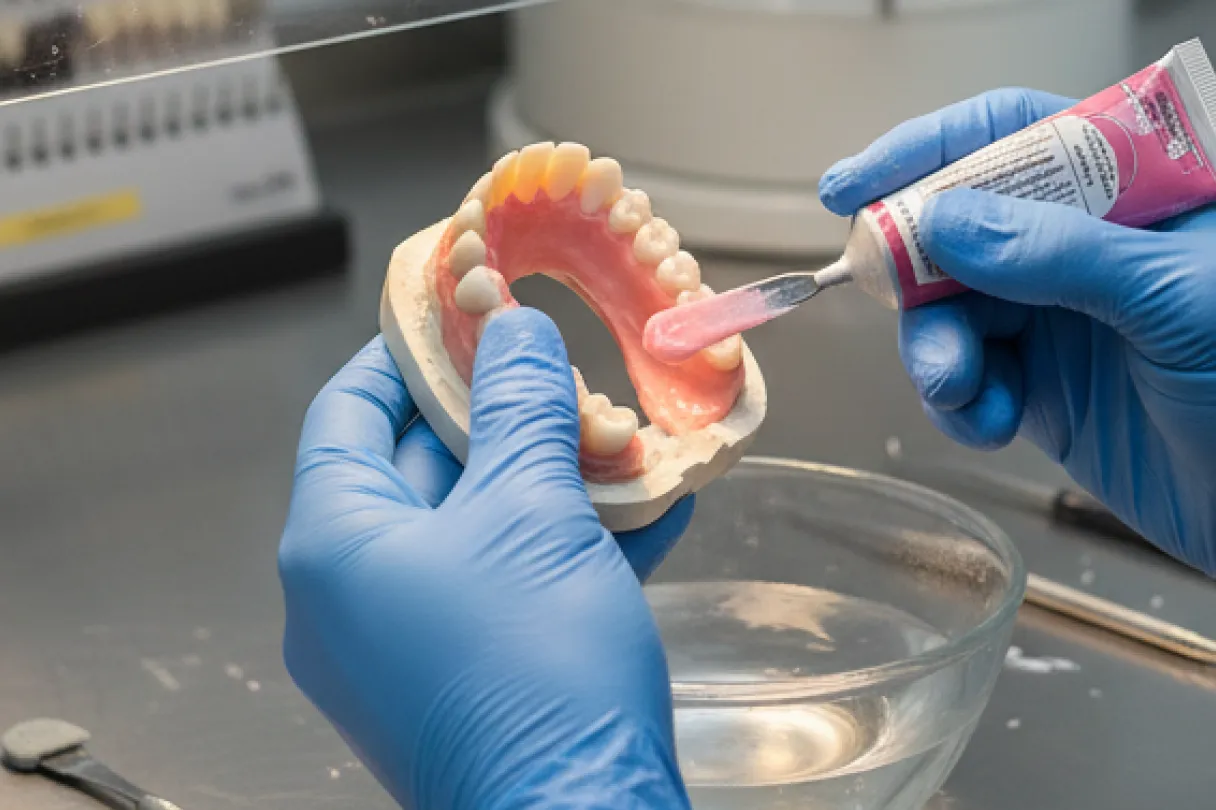 Denture base being relined with new material to improve its fit against the gums