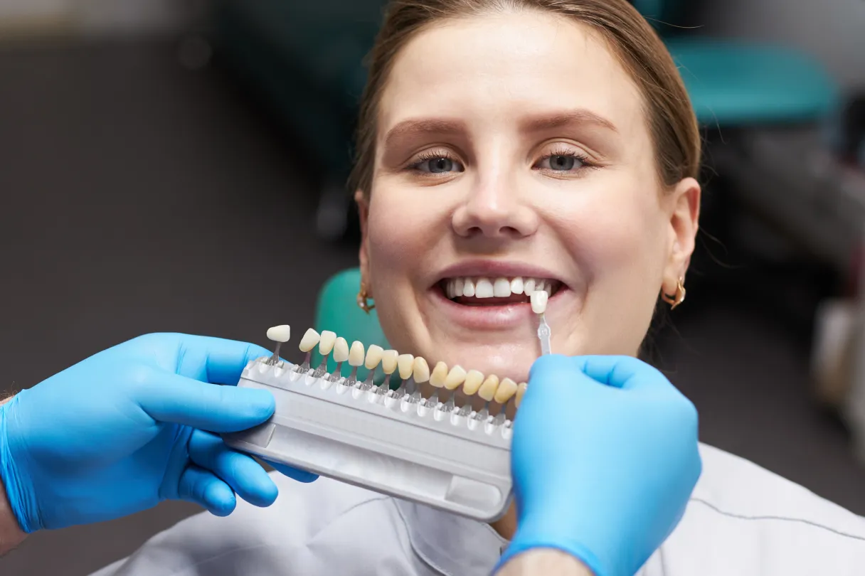 Implants, a bridge, and dentures displayed together as permanent tooth replacement options