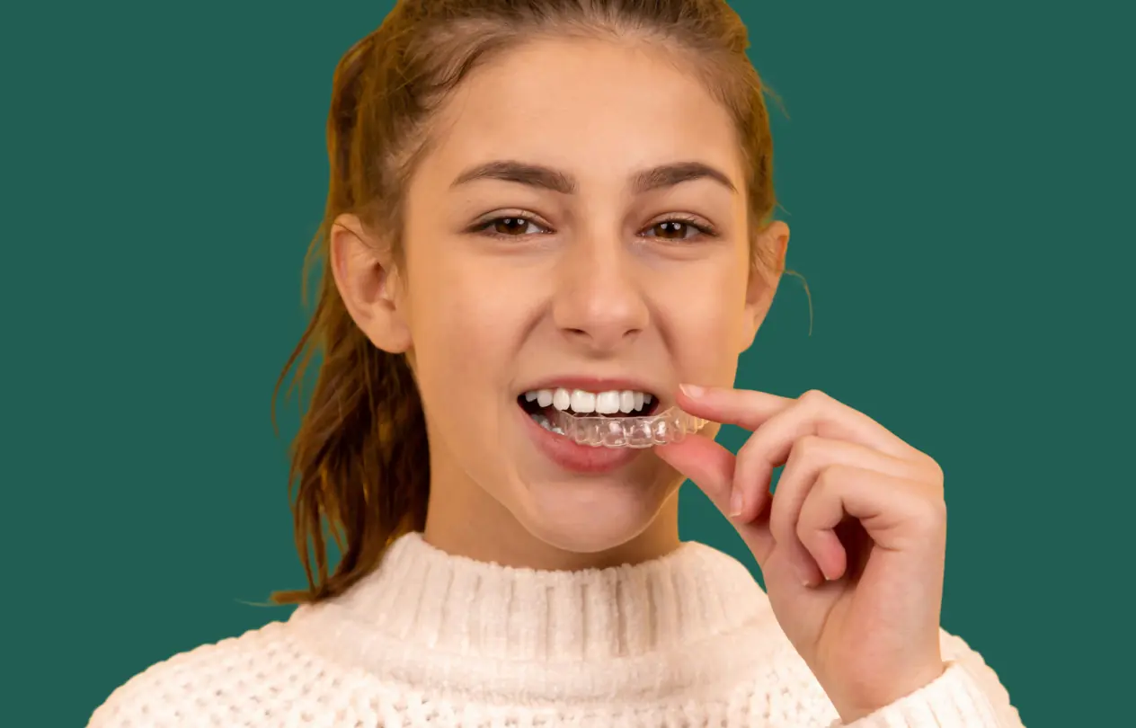 Clear Invisalign aligner tray held up to show the discreet orthodontic treatment