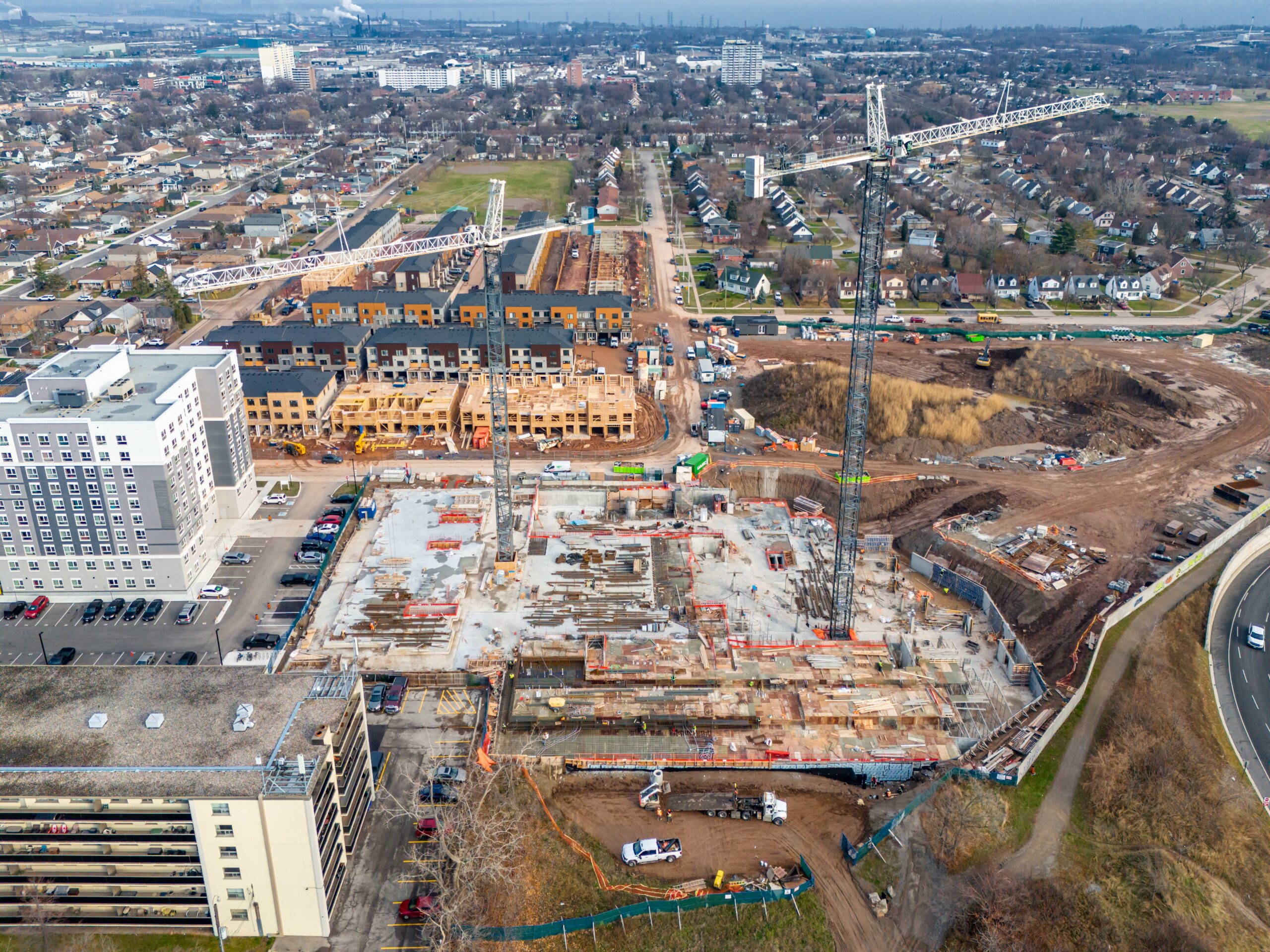 Aerial view of the Roxboro Development construction site, showing cranes, foundation work, and surrounding residential neighbourhoods.