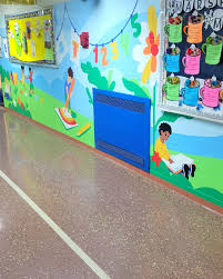 Colorful educational mural decorating a school hallway with children