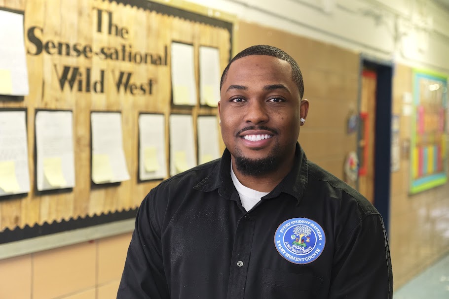 Mr. Fowler smiling in a PS 262 school hallway