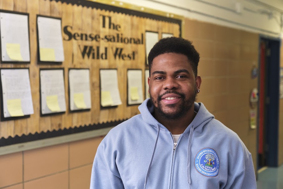 Mr. Beauchamp smiling in PS 262 school hallway