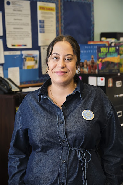 Ms. Rodriguez smiling in a school office setting