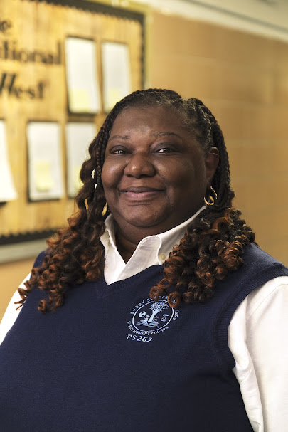 PS 262 staff member Ms. Slater-Nevels smiling in school uniform
