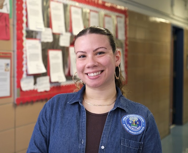 PS 262 staff member Ms. Cordova smiling in school hallway