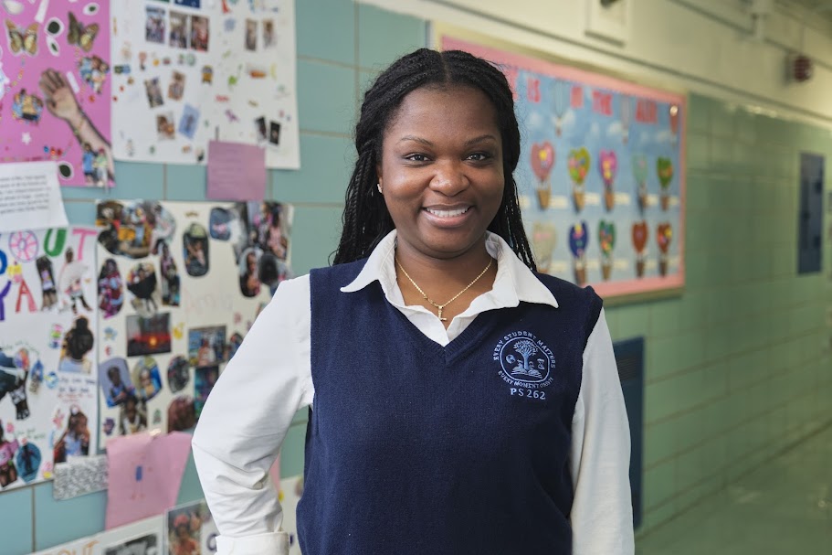 PS 262 staff member Ms. Gabb smiling in school hallway