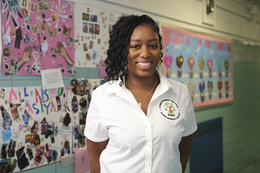 PS 262 staff member Ms. Vincent smiling in school hallway