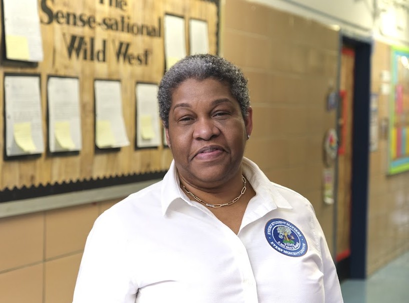 Ms. Robinson staff member standing in school hallway
