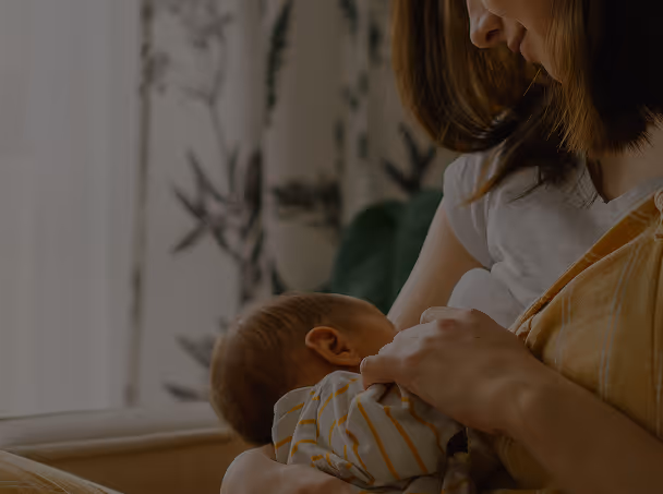 woman breast feeding baby