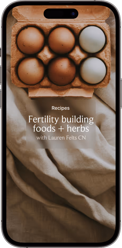 Smartphone screen showing a recipe titled 'Fertility building foods + herbs with Lauren Felts CN' over a background of a carton with brown and white eggs on beige fabric.