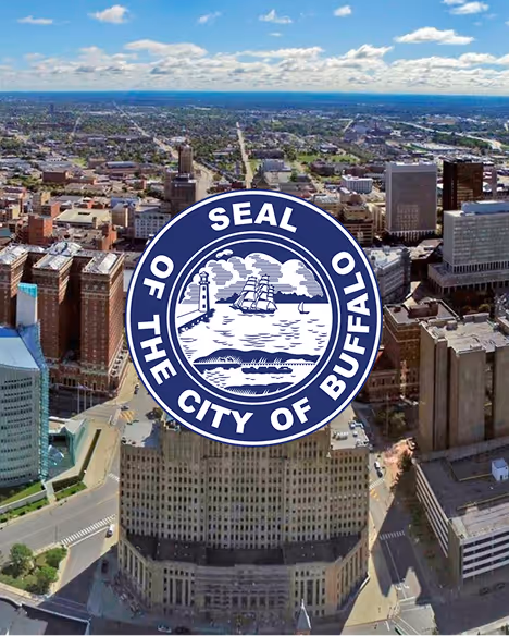 Aerial view of downtown Buffalo with the city's official seal overlay depicting a lighthouse, sailing ship, and water.