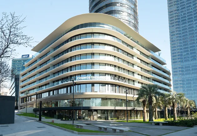 A modern building with a curved facade in a city.
