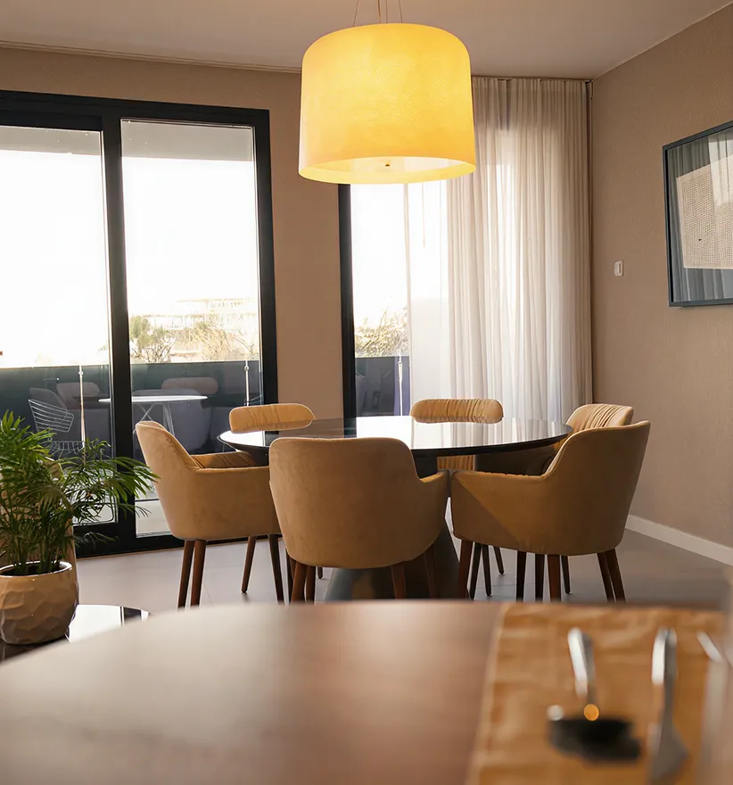 A dining room with a table and chairs.