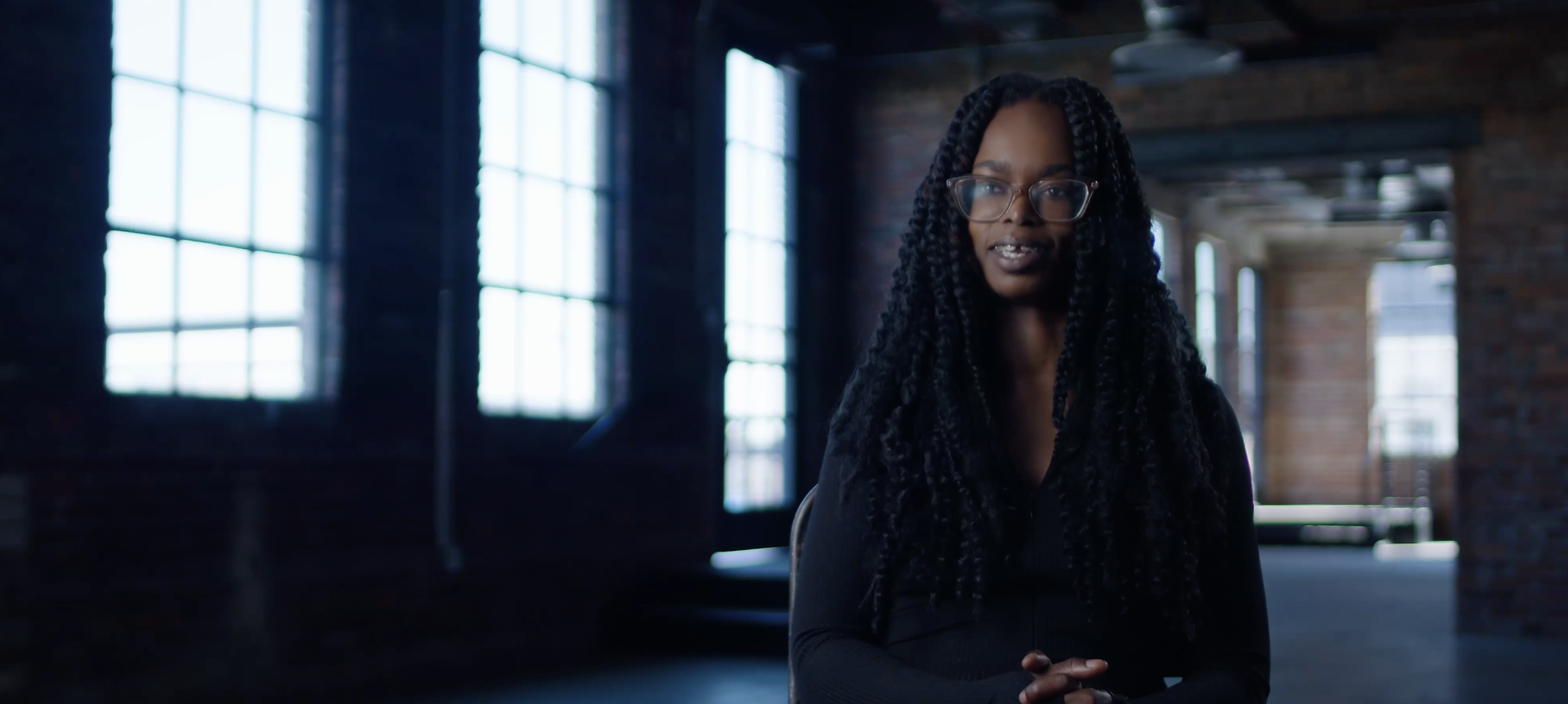A young black woman looks out at the camera, with an overlaid text that reads 