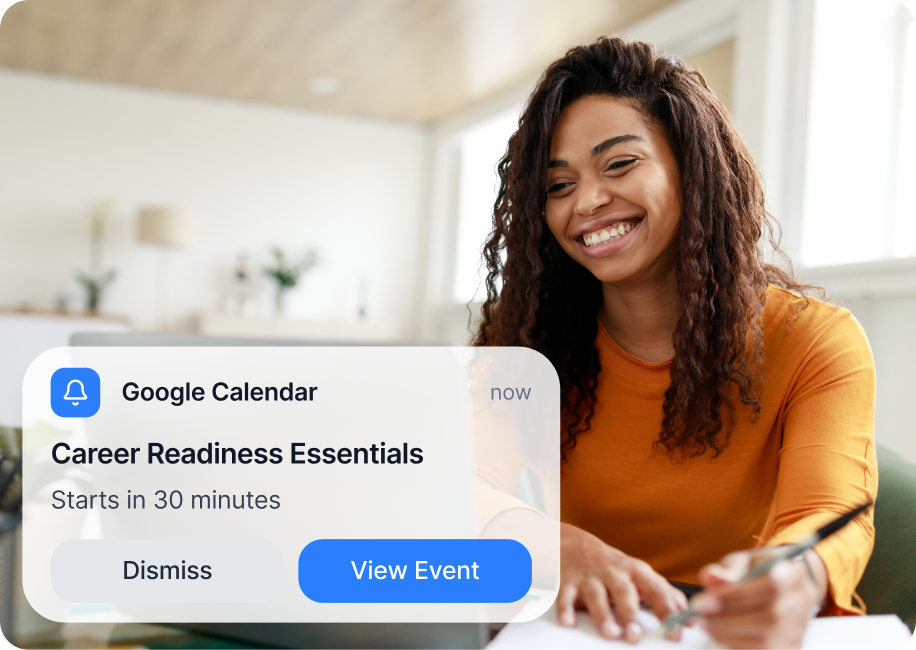 An image of a woman using a laptop with a Google Calendar event reminder on screen