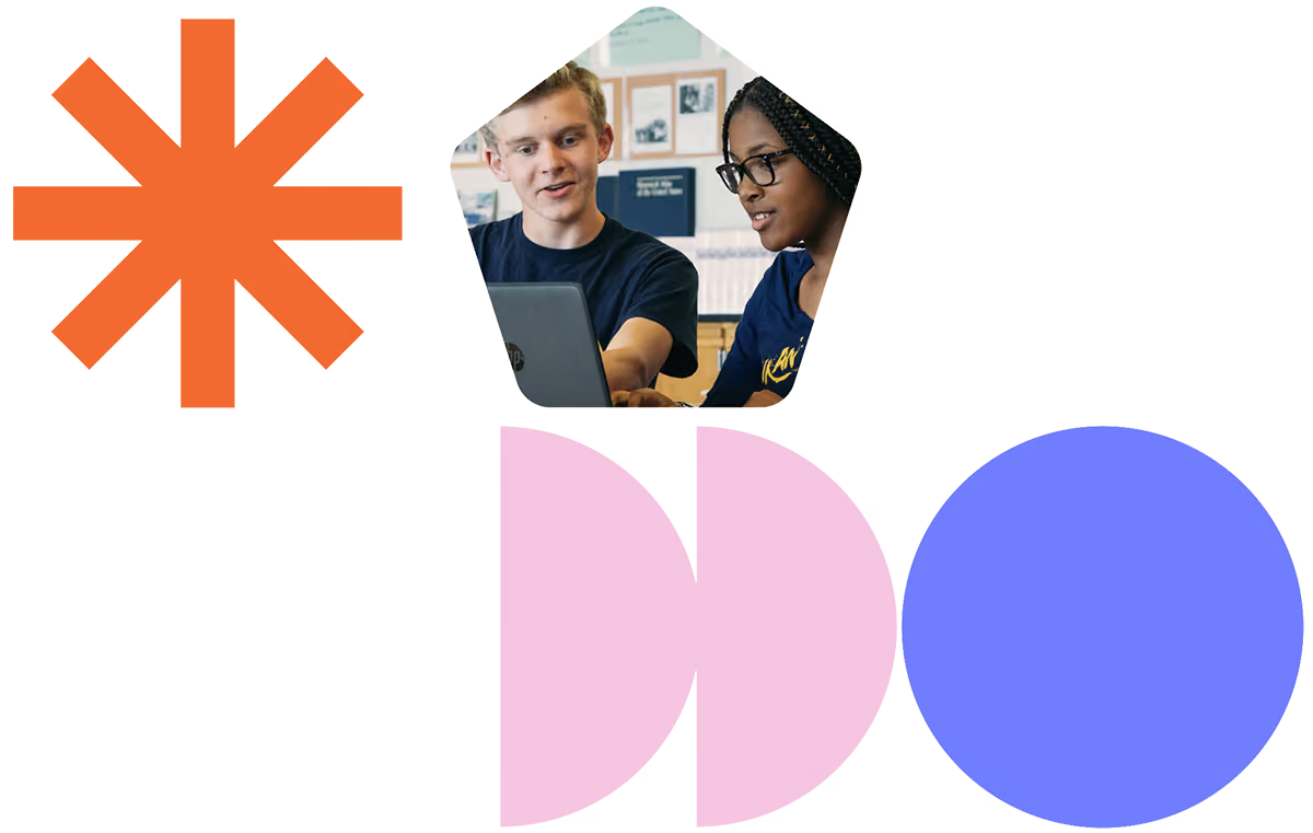 Two students working together on a laptop in a classroom setting with geometric shapes around.