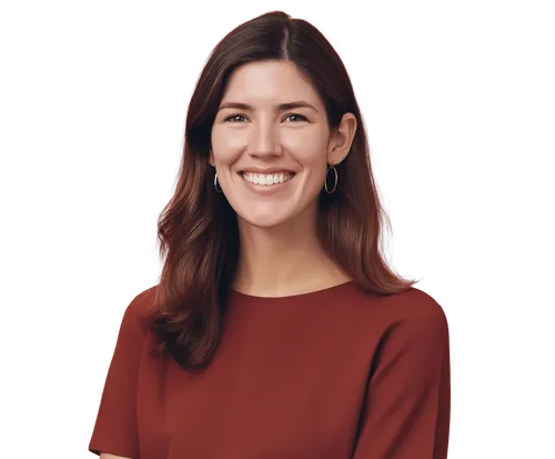 Smiling woman with long brown hair wearing a maroon top and hoop earrings.