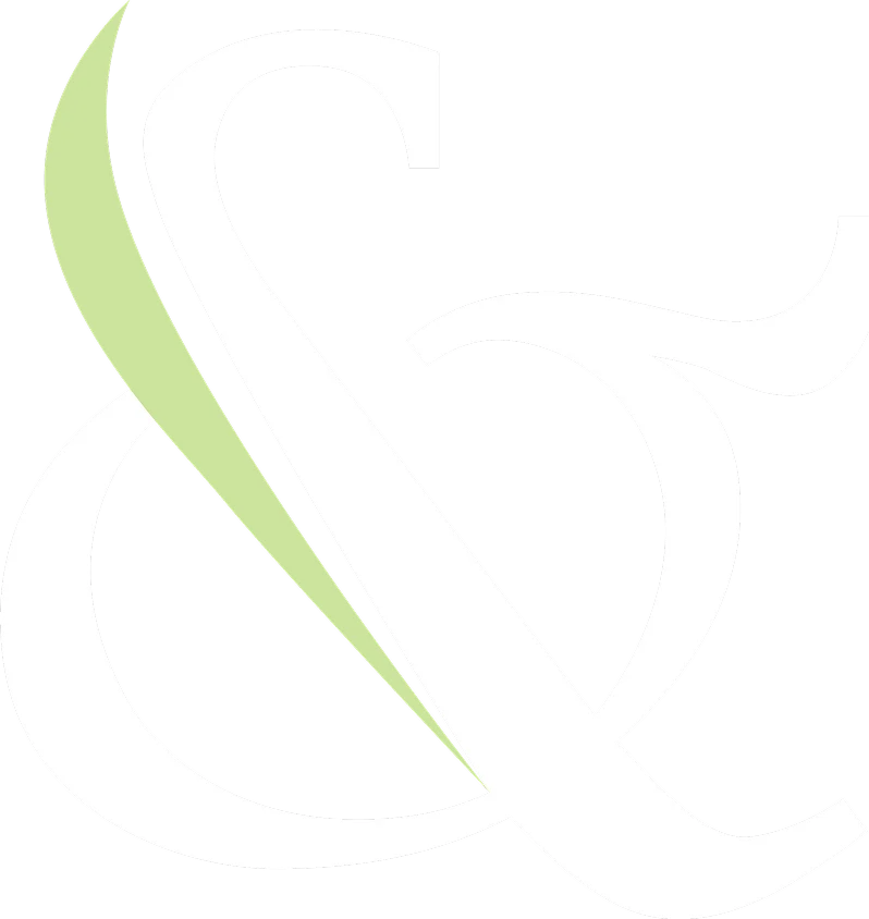 Stylized ampersand symbol with white and green design elements on a black background.