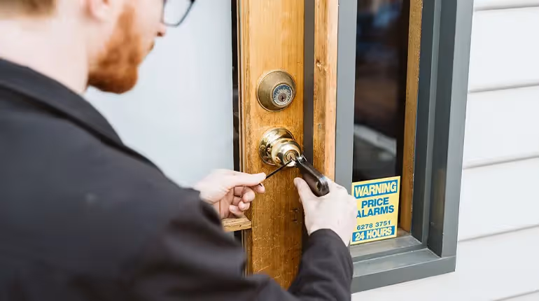 A Tasmanian Mobile Locksmith specialist installing a new door lock on a Hobart home.