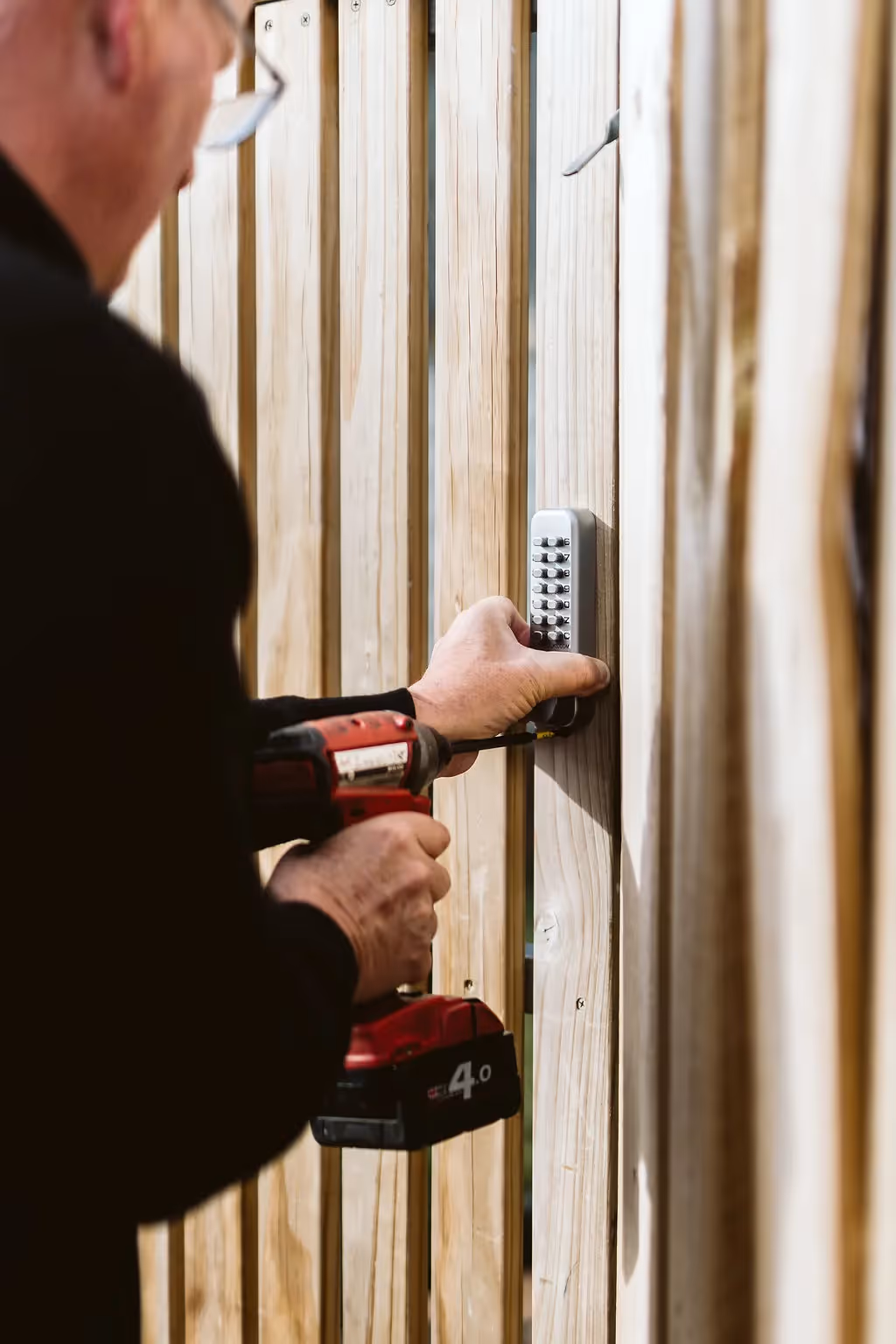 One of our Master locksmiths attaching an external code lock to the staff door of a business in Hobart.