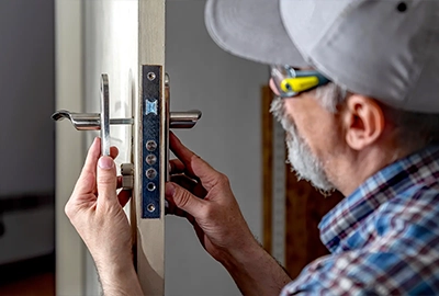 One of our locksmiths carefully installing a new lock on an internal door of a Hobart home.