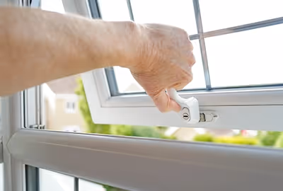 A closeup of one of our locksmiths’ hands as he opens and shuts a newly fitted window lock in a home in Hobart.
