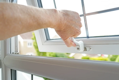 A closeup of one of our locksmiths’ hands as he opens and shuts a newly fitted window lock in a home in Hobart.