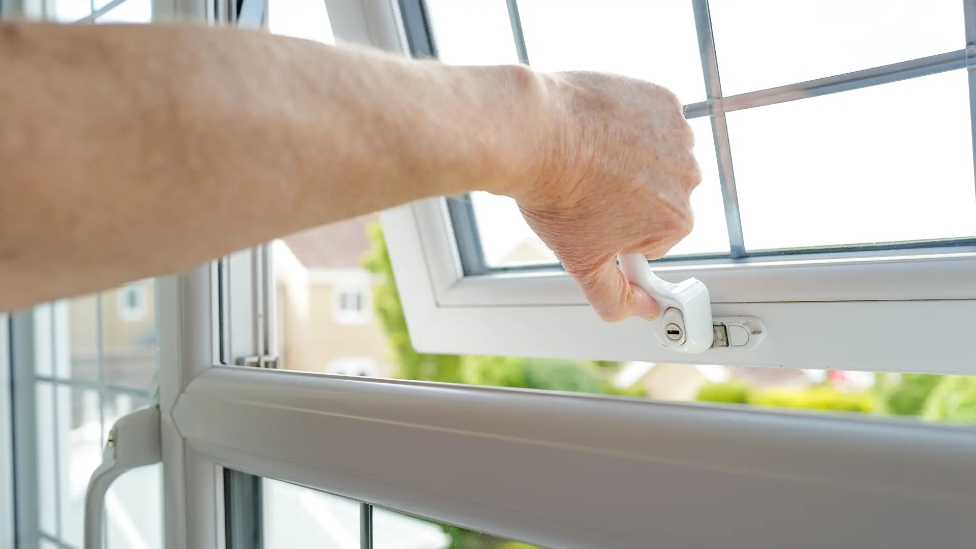 A closeup of one of our locksmiths’ hands as he opens and shuts a newly fitted window lock in a home in Hobart.
