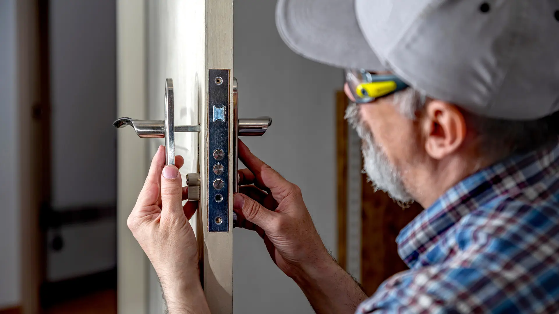 One of our locksmiths carefully installing a new lock on an internal door of a Hobart home.