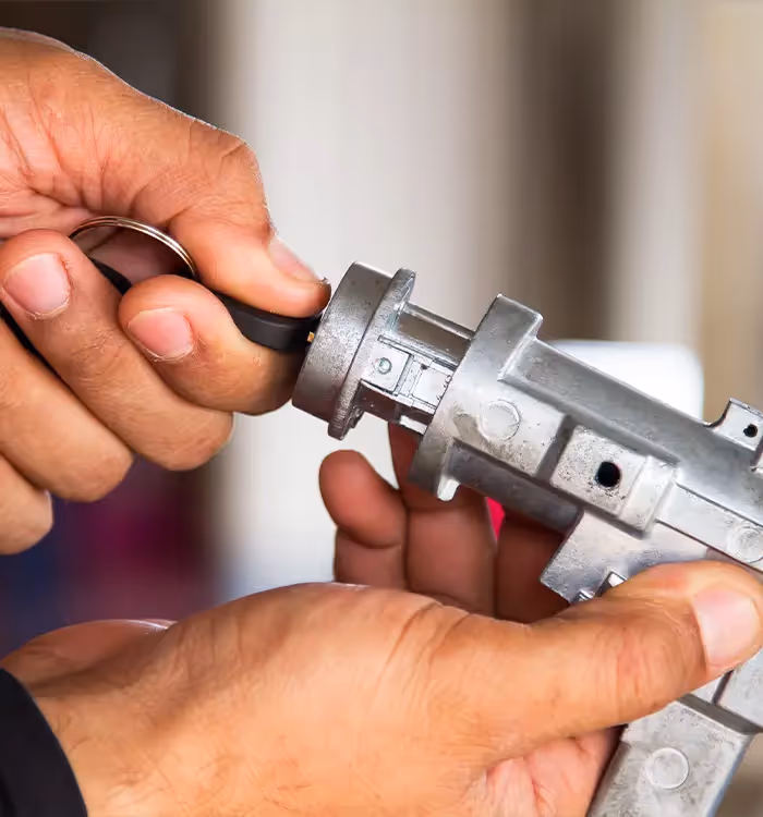 Closeup of the hands of one of our locksmiths as they test a new key for a safe one of our clients wants installed in their home.