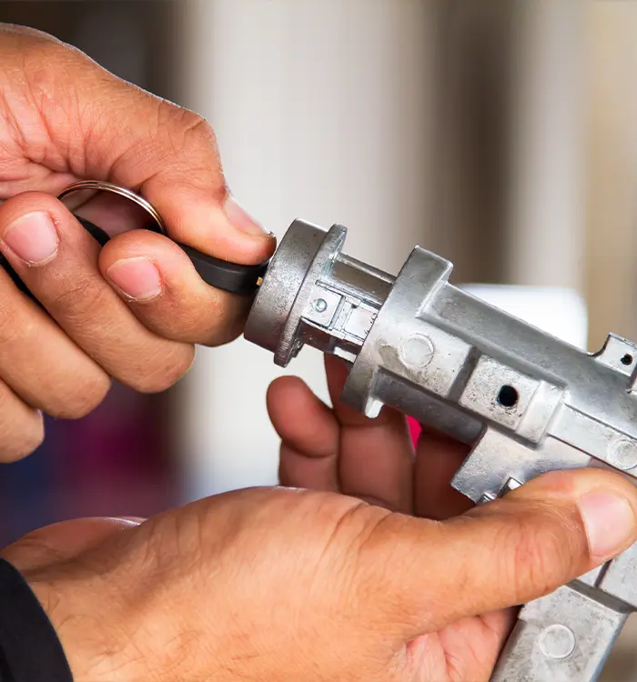 Closeup of the hands of one of our locksmiths as they test a new key for a safe one of our clients wants installed in their home.