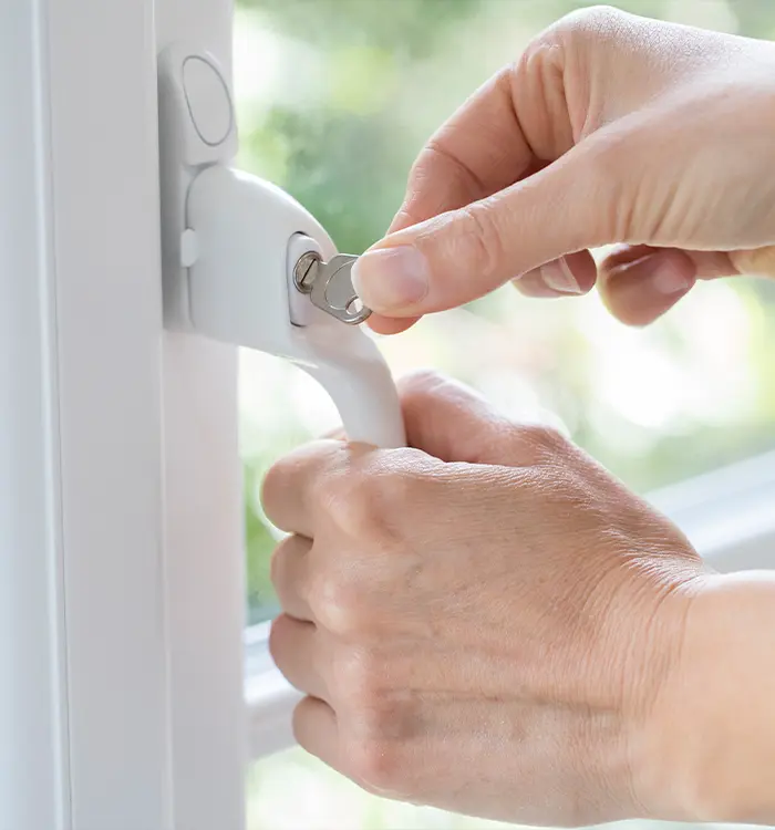 A closeup of one of our locksmiths’ hands as he tests the key on a newly installed window lock at a home in Hobart.