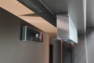 Commercial-grade electromagnetic lock attached to a wooden door frame at a commercial business in Hobart.