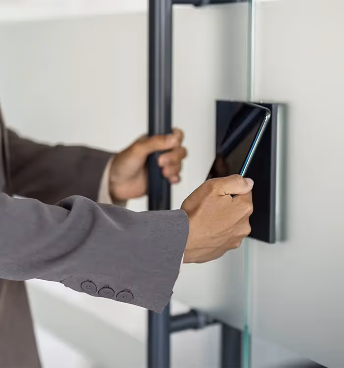 Hand scanning access card at secure electronic door entry system