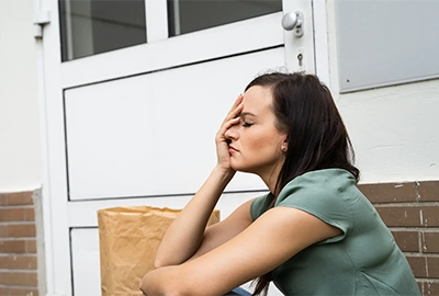 A frustrated woman sitting on her porch with her groceries. She’s accidentally locked herself of our her home. Our lockout locksmiths help Hobart locals get back in ASAP.