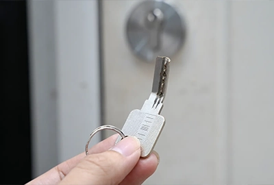 A close-up of a client’s hand holding a bent house key. This happens all the time, and our broken key extraction locksmiths help Hobart clients with issues like this all the time.